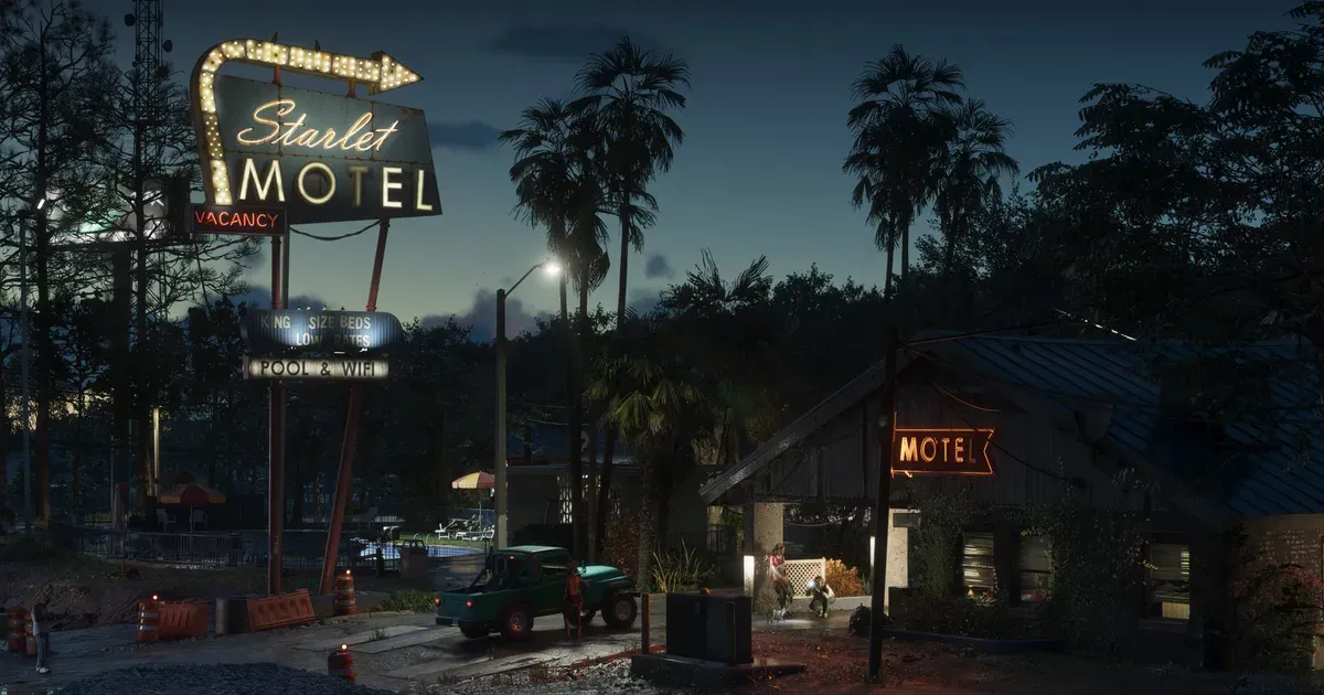 A faded motel and strip mall lit at night in GTA 6, the run-down aesthetic of Port Gellhorn